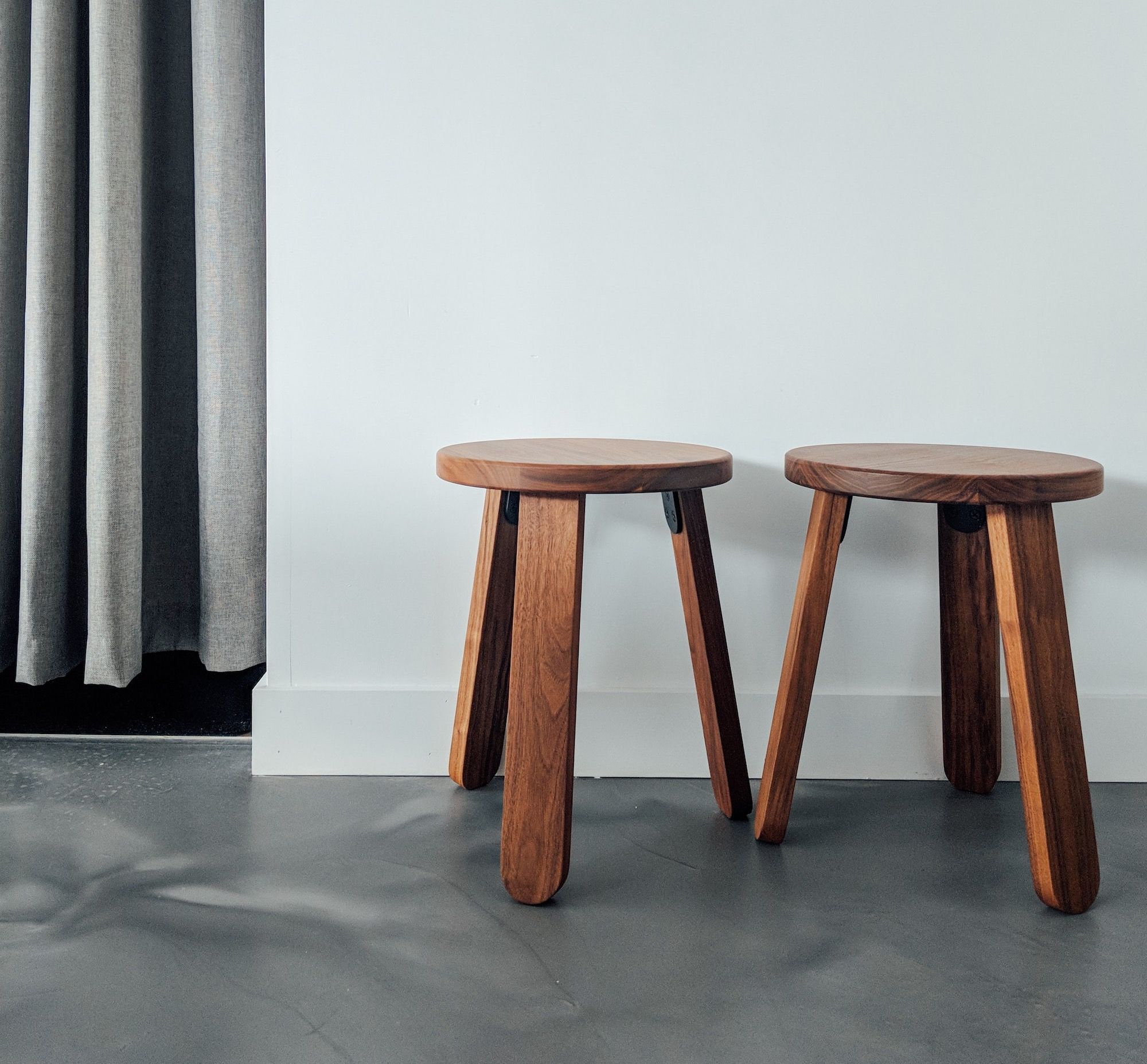 two brown wooden stools